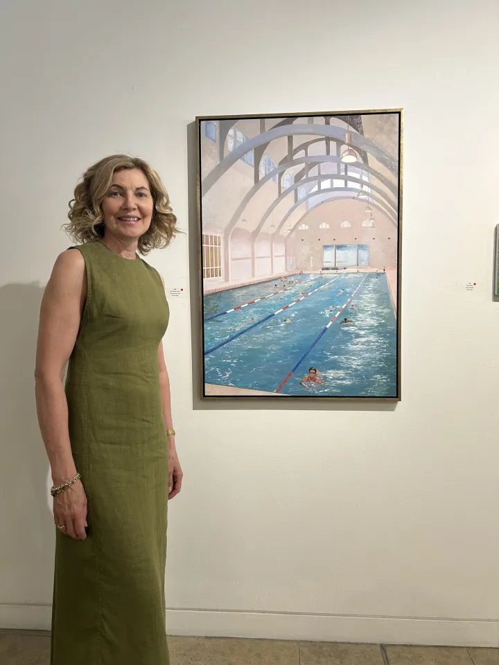 Avril standing beside The Swimming Pool painting